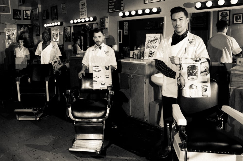 The Downtown Vintage barbers in the shop with vintage barber chairs