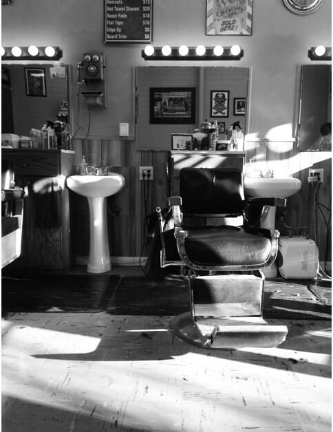 Inside Downtown Vintage Barbershop — vintage barber chair, mirrors, and sinks